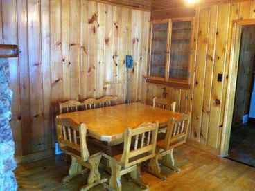 Sit down with your family and enjoy this knotty pine dining area. The whole cabin is knotty pine. 