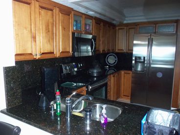 The kitchen was redone in 2012. The ceiling was replaced, the cabinets are now all wood and the appliances are all stainless steel.