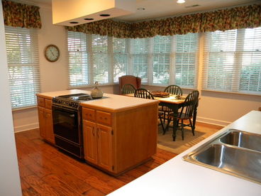 Lots of windows; island stove/oven combo; plenty of seating for guests.  All pots and pans, dishes, flatware etc. are furnished.