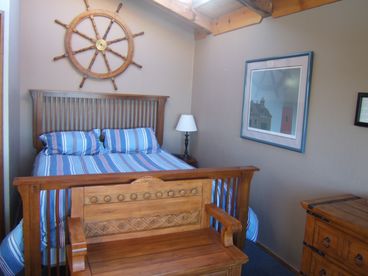 Our most popular room, room 2 features a comfy queen bed.  Sit on the bench to take in the beautiful water views.  Also features wood beam ceilings with skylight, 