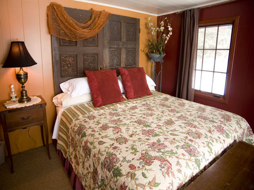 The Lake View Suite - king size bed and great view of the lake. The largest of 7 bedrooms. Bathroom can be private, or by opening an accordian door, accessible for the rest of the guests.