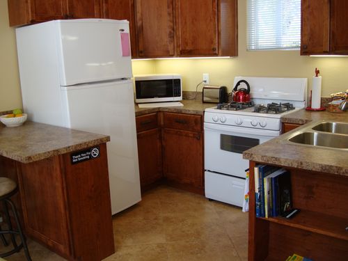 Kitchen - Fully stocked, includes a fridge with an ice-maker and a microwave.