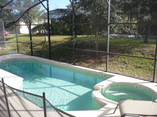 private pool and spa, full screen enclosure, removable child safety fence, patio & lounge chairs, BBQ