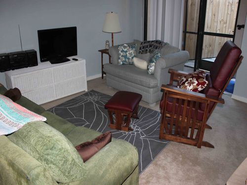 Living room with sofa, loveseat, glider chair, TV, DVD, cable and wi-fi.