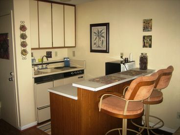 Full kitchen with an oven, stove, dishwasher microwave, coffee maker, toaster, and  blender.