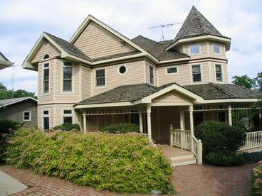 Walk the wrap around porch to the lake side of the estate to get great views to the pier and shoreline.