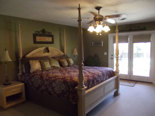 King Bedroom with electric fireplace and doors to the pool patio