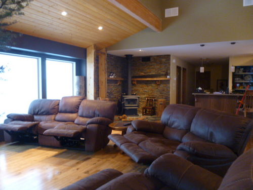 Great room with 5 recliners and wood burning fireplace in the background