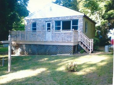 Stone front cottage with a 22\' patio and sits on 1/2 acre with trees surrounding.
