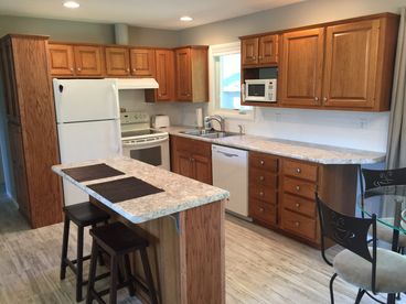 Beautiful kitchen with full amenities including well stocked cooks kitchen, dishwasher, disposal, and beautiful view to the private back yard. 