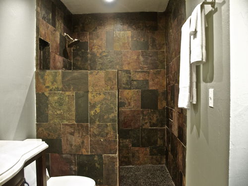 updated shower with natural stone slate tiles