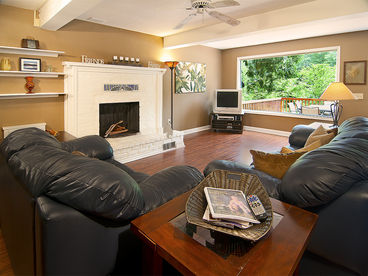 Spacious living room with fireplace and amazing river views.