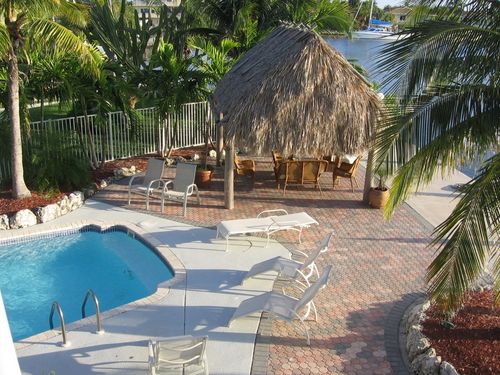 Large private Pool with Tropical Waterfront Tiki Hut