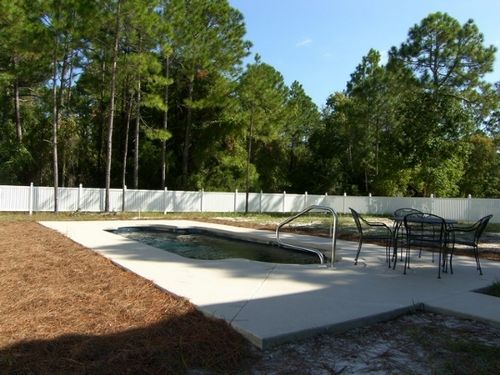 Pool is currently being installed.  This is a picture of a nearly identical property\'s pool and backyard.