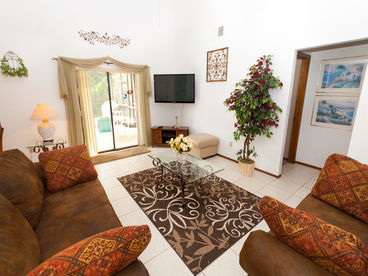 Spacious lounge with 51inch flat screen HDTV and 250 digital + HD channels , overlooking pool and conservation area beyond.