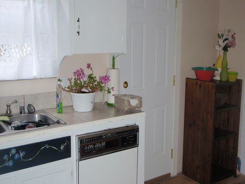 Full kitchen with door leading to back patio.