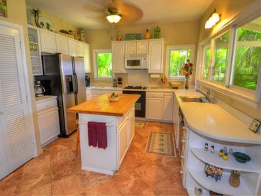 Fully equipped kitchen, side by side refrigerator with ice maker, view