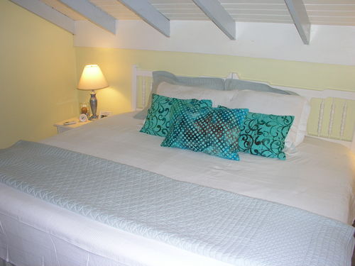 The upstairs bedroom is decorated in soothing aqua blue hues. It is air-conditioned, which cools the entire apartment. Two twin beds together create a king, or can be separated if you prefer.