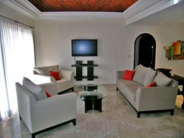 bright and spacious living room with dome brick vaulted ceiling