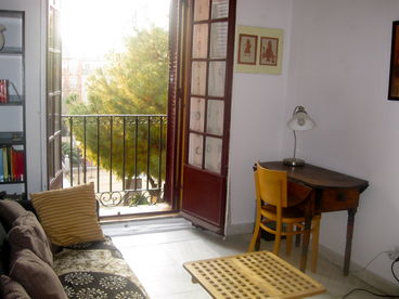 living room, with balcony facing onto plaza