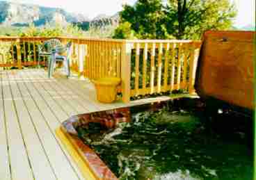 View the red rocks from the private deck and sunken hot tub off of the master bedroom.