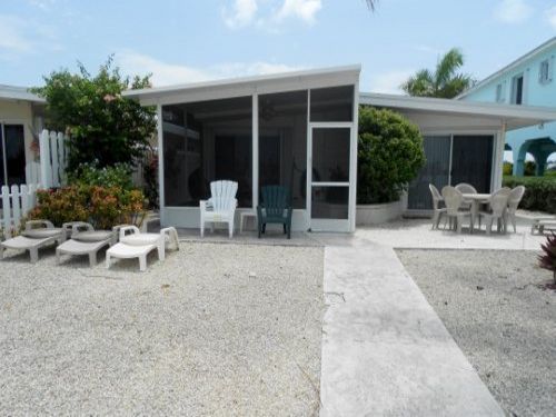 Rear of House Features Screened in Porch with Outdoor Seating for Six