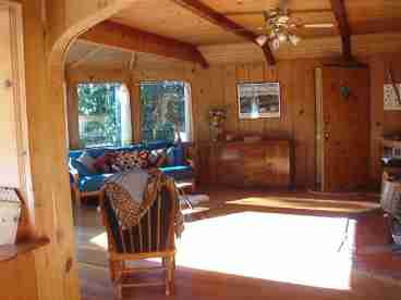 Western sunlight baths the hardwood floor in the living room.