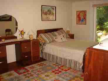 The large bedroom offers sliding doors out to the very private deck overlooking the woods.