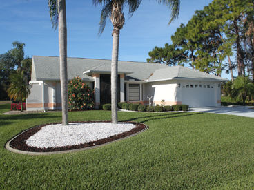 Exterior of house overlooking vacant lot.