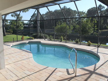 Newly Remodelled south west facing pool and lanai, overlooking canal.
