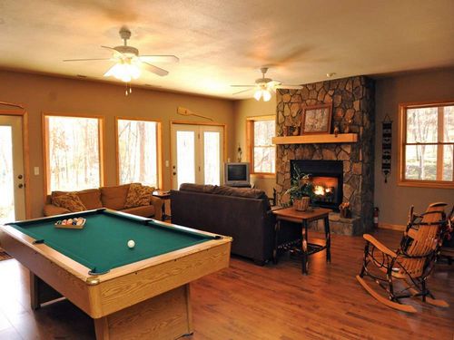 Game room with convertible pool/ping pong table and fireplace.