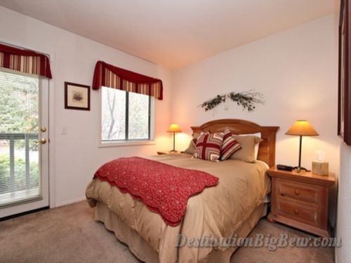 Bedroom with a queen bed and private balcony