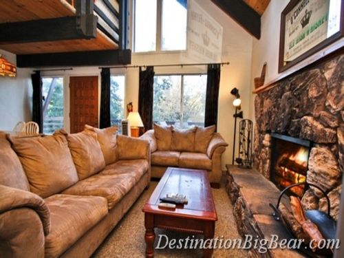  The downstairs features a family room accented by the large wood burning fireplace