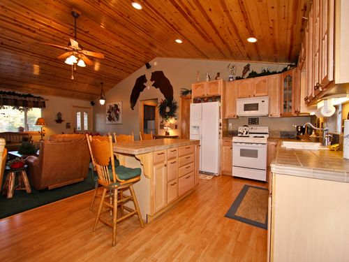 A grand kitchen, including dishwasher, microwave, custom counter tops