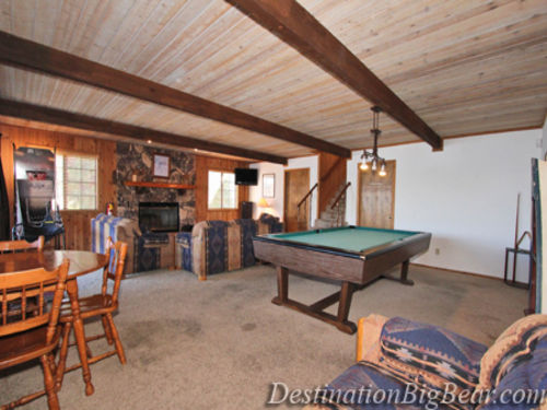 The downstairs living room is also the GAMEROOM with another wood burning fireplace and POOL TABLE