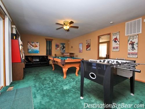 The large GAME ROOM  features a POOL TABLE and a FOOSBALL TABLE,  flat screen TV and DVD player