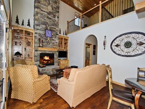 The family room which features a flat screen TV and DVD player as well as a cozy wood burning fireplace.  