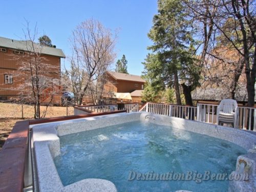 The backyard features a warm and inviting HOT TUB