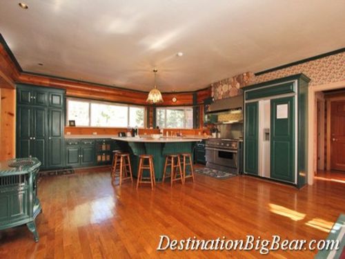 The kitchen has granite counter tops with center island and table seating for 12