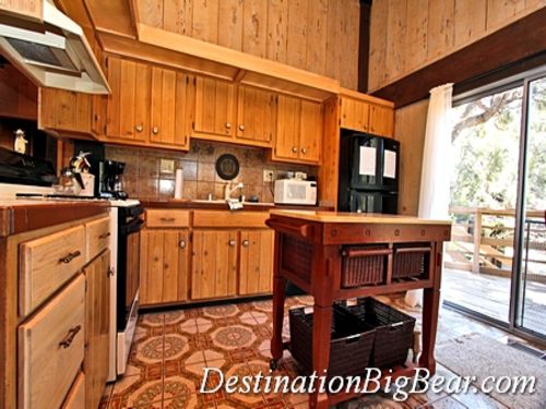 The bright and spacious kitchen with a lovely view of the forest