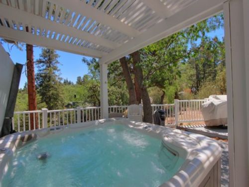 Relax in the outdoor HOT TUB and the large deck facing beautiful pine trees