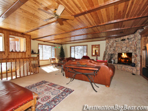 The family room circles a rock wood burning fireplace where you can snuggle up
