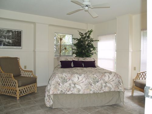 Bedroom with his & hers closets and garden views.