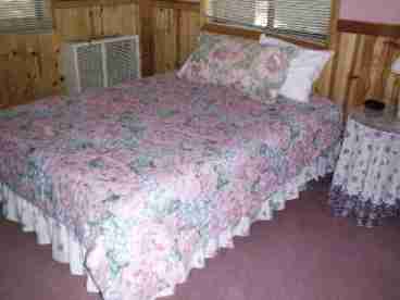 Queen bed in front of the fire and jacuzzi.