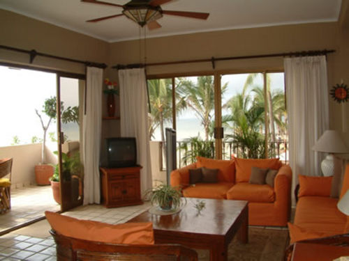 Cable TV (English and Spanish), Chairs, Sofas, and 3 sliding glass doors to a wrap around oceanfront patio