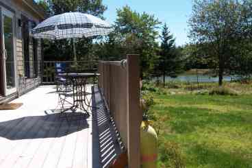 Rear of Cottage & Deck looking towards estuary; deck faces cove with meadow in foreground has views all along the estuary
