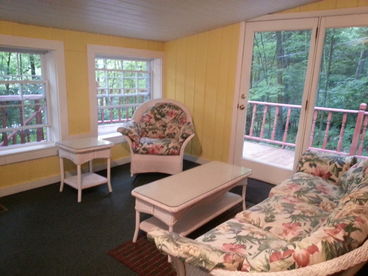 Sunroom with high-end wicker furniture; Overlooks valley below