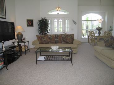 Large, bright and airy Living Room with Cable TV. Formal dining area for six people beneath beautiful chandelier. 