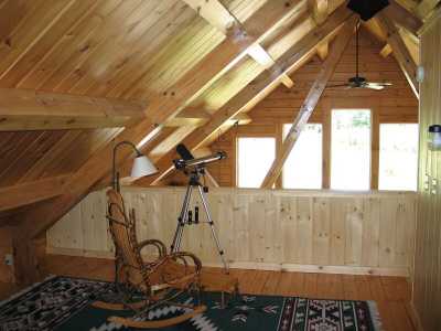 The upper level of this fine log home serves as the largest sleeping area with private 1/2 bath. Morning views await your awakening. Is that a Moose in the front yard?