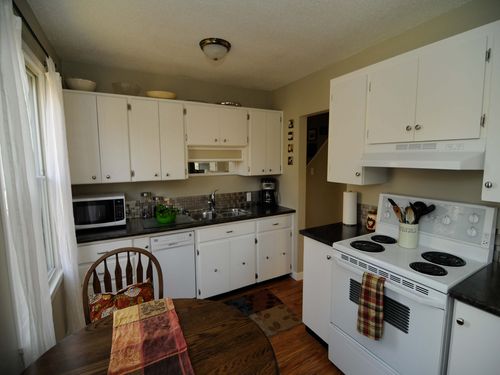 Kitchen has a dining room table with 4 chairs